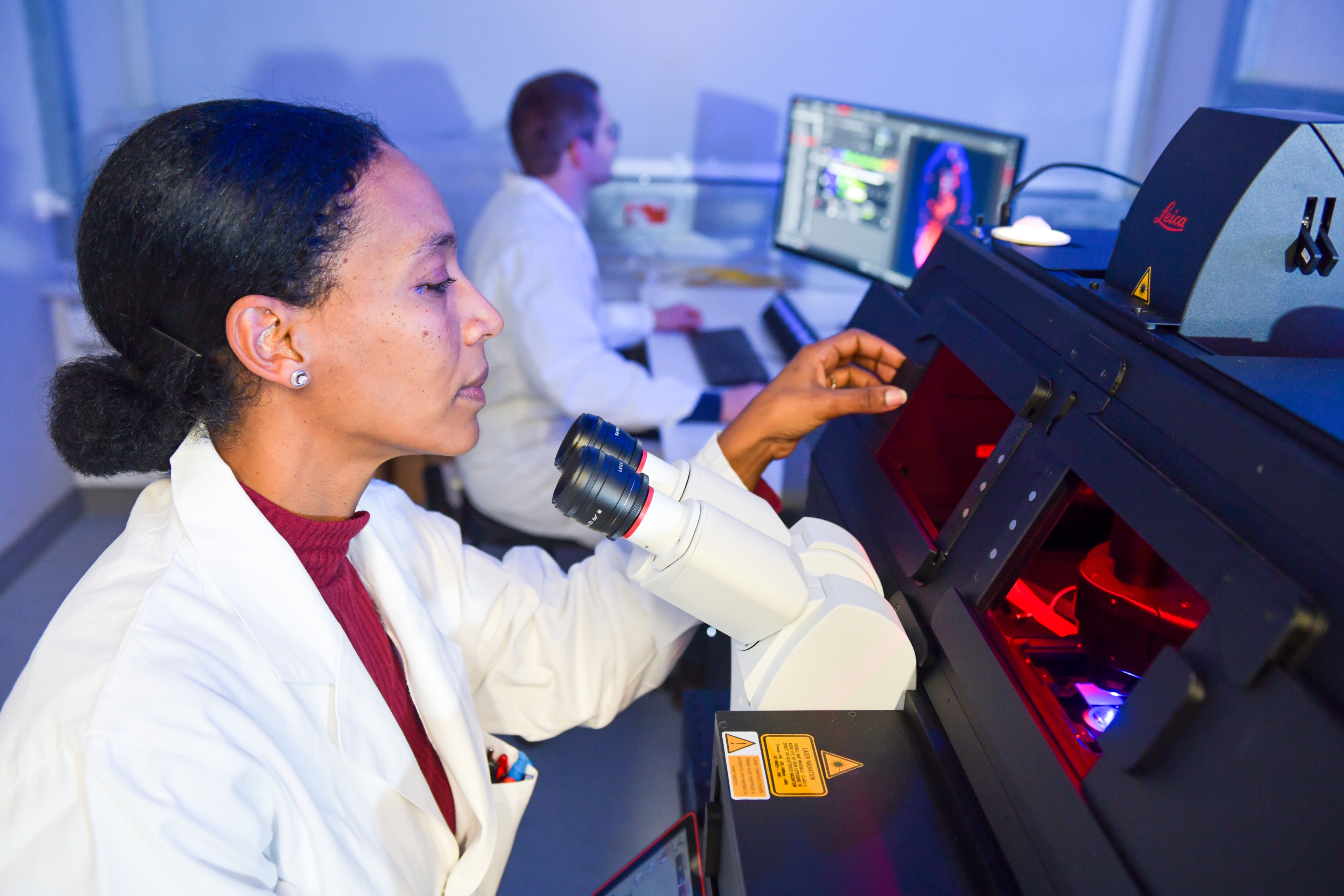 scientists at microscope